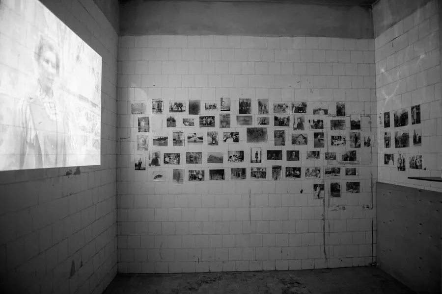 The room with the projection and the photographs of Anna on the tiles