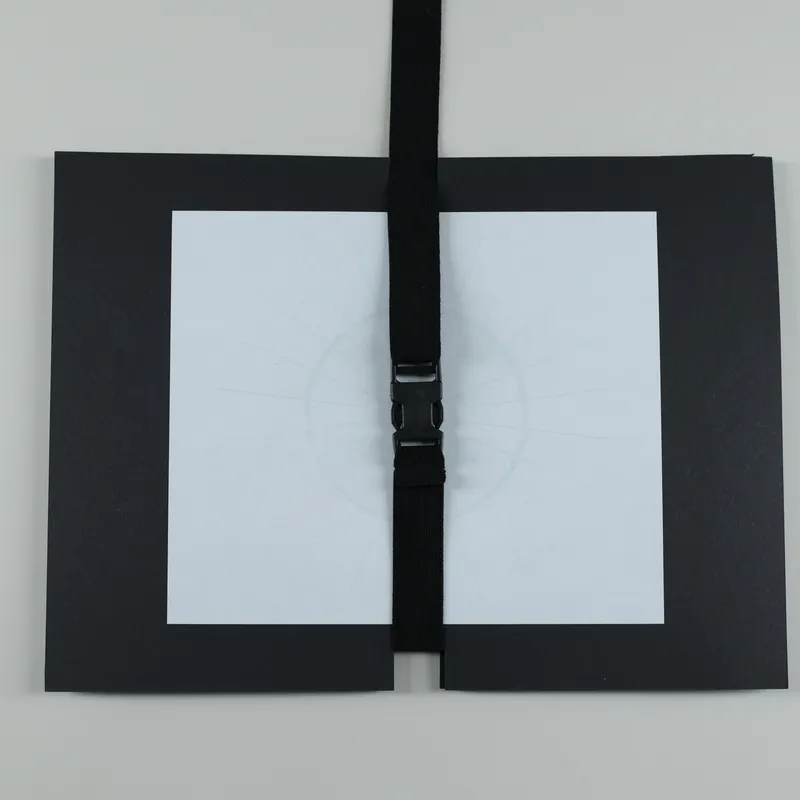 The book in a folder with a strap